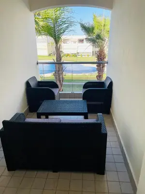 a room with four chairs and tables and a window at Ola blanca 1 enjoy in Sidi Rahal