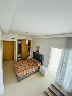 a bedroom with a bed and a large window at Ola blanca 1 enjoy in Sidi Rahal