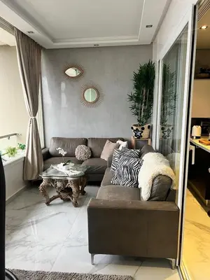 a living room with a couch and a table at Appartament Melrose beach dar bouazza in Tamaris