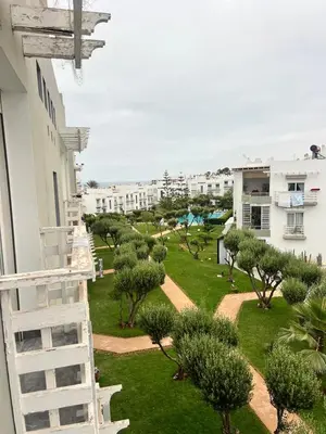 a view from the balcony of a building with trees at Appartament Melrose beach dar bouazza in Tamaris