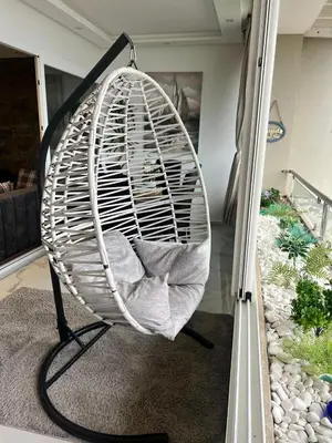 a large swinging chair in a living room at Appartament Melrose beach dar bouazza in Tamaris