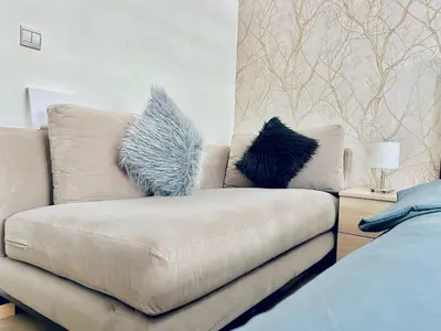 a couch with two pillows on it in a living room at Apartment in rabat agdal in Rabat