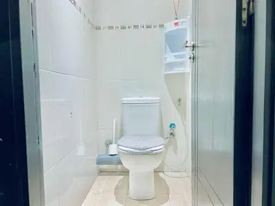 a white bathroom with a toilet and a shower at Apartment in rabat agdal in Rabat