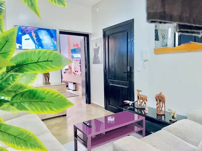 a living room with a couch and a purple coffee table at Apartment in rabat agdal in Rabat