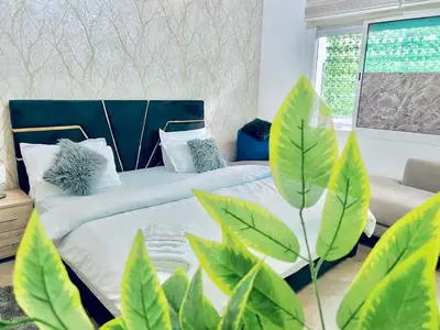 a living room with two beds and a couch at Apartment in rabat agdal in Rabat