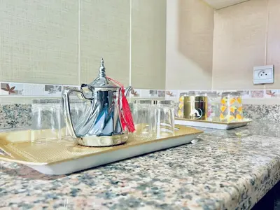 a glass jug on a counter in a kitchen at Apartment in rabat agdal in Rabat