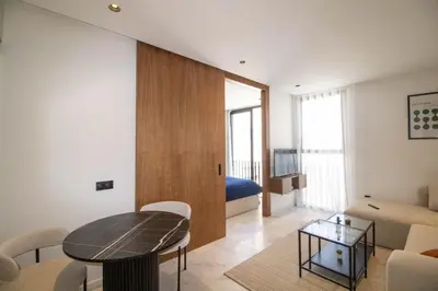 a living room with a table and a bedroom at Comfort & Premium in Casablanca