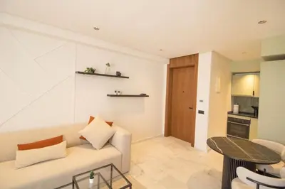 a living room with a couch and a table at Appartement Ferme Bretonne - Confort & Premium in Casablanca