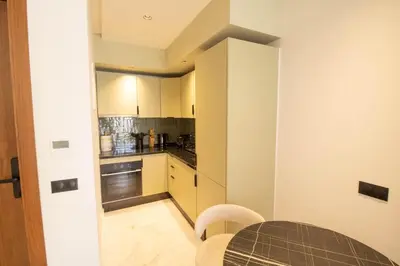 a small kitchen with a table and chairs in a room at Appartement Ferme Bretonne - Confort & Premium in Casablanca