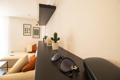 a pair of glasses sitting on a table in a living room at Appartement Ferme Bretonne - Confort & Premium in Casablanca