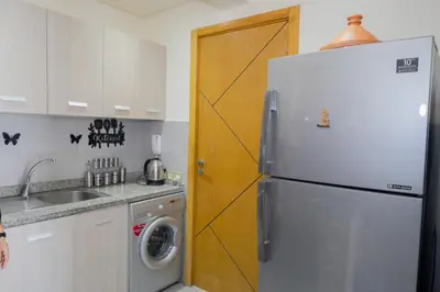 a kitchen with a refrigerator and a washing machine at R106- Amazing & Colourful Apartment near High Speed Train Station in Casablanca