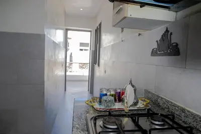 a kitchen with a stove and a counter top at R106- Amazing & Colourful Apartment near High Speed Train Station in Casablanca