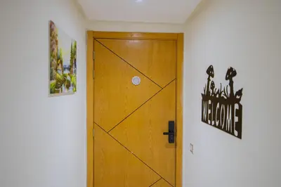 a wooden door in a hallway with a sign on it at R106- Amazing & Colourful Apartment near High Speed Train Station in Casablanca