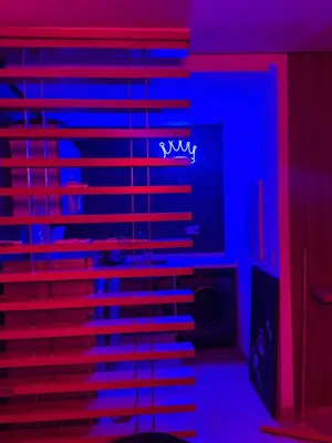 a room with a bed with blue and red lights at Studio a maarif in Maarif
