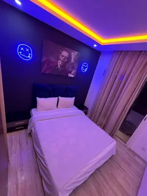 a bedroom with a white bed and a tv on the wall at Studio a maarif in Maarif