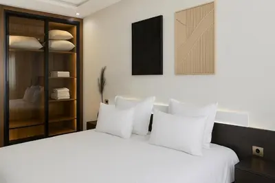 a bedroom with a white bed with white pillows at Rooftop in Maarif