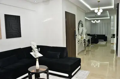 a living room with a black couch and a table at Rooftop in Maarif