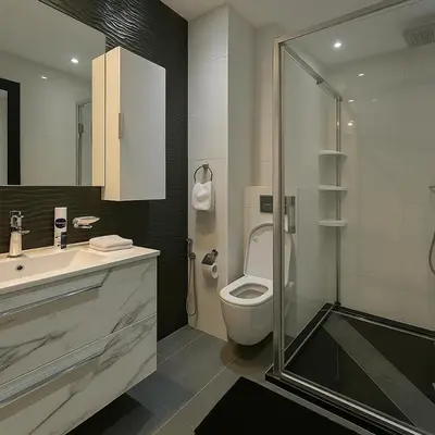 a bathroom with a toilet and a sink and a shower at Rooftop in Maarif