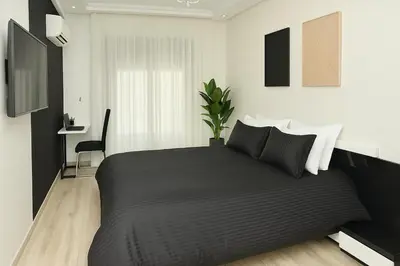a bedroom with a black bed with a plant on it at Rooftop in Maarif