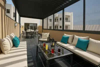 a living room with a couch and a table at Rooftop in Maarif