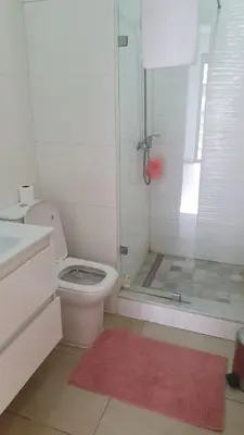 a bathroom with a shower and a toilet and a sink at Ground floor apartment - Residence Skhirat Beach 2 in Skhirat