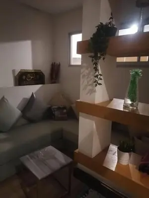 a living room with a couch and a table at Apparemment haut standing Mansbay in Mohammedia