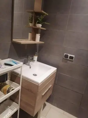 a bathroom with a sink and a mirror at Apparemment haut standing Mansbay in Mohammedia