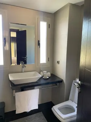 a bathroom with a sink and a toilet at Cozy beach house in Skhirat