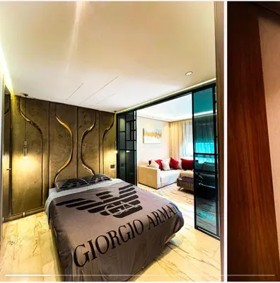 a bedroom with a bed and a living room at Studio luxueux in Casablanca