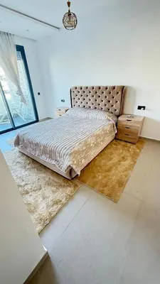 a bedroom with a large bed in a room at luxury apartement en el mansouria in Pont Blondin