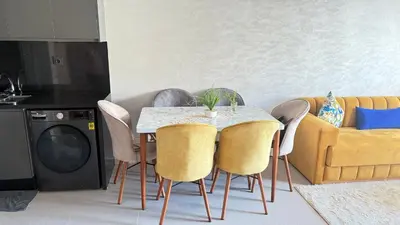 a dining room with a table and chairs and a couch at luxury apartement en el mansouria in Pont Blondin
