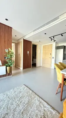a large living room with a table and a rug at luxury apartement en el mansouria in Pont Blondin