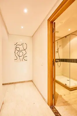 a bathroom with a shower and a glass door at Casablanca 3 Bed Unit in Triangle Dor With Parking in Casablanca
