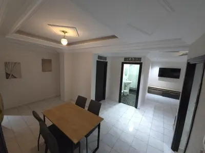 a dining room with a wooden table and chairs at Havre de paix en plein coeur de Casa in Casablanca
