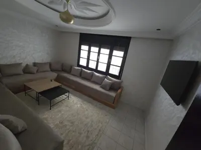 a living room with a couch and a table at Havre de paix en plein coeur de Casa in Casablanca