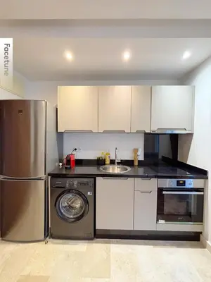 a kitchen with a stainless steel refrigerator and a dishwasher at Studio cosy in Casablanca