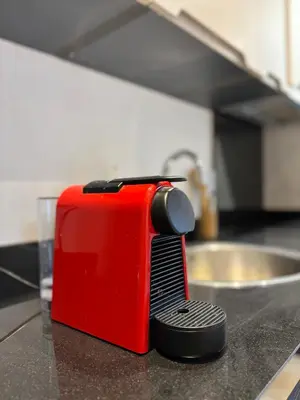 a red toaster sitting on top of a kitchen counter at Studio cosy in Casablanca