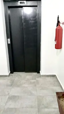 a black door in a room with a fire extinguisher at Charming Studio for Rent with Pool Access & Kids Playground in Casablanca
