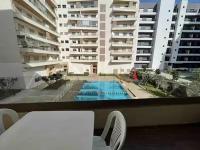 a view of a swimming pool from the balcony of a apartment at Charming Studio for Rent with Pool Access & Kids Playground in Casablanca