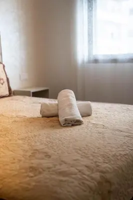 a bed with a towel on it with a window at Charming Studio for Rent with Pool Access & Kids Playground in Casablanca