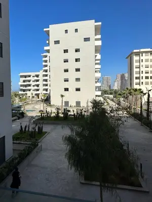 a person riding a skateboard in front of a building at Studio Confortable avec Balcon, Piscine, Jardin et Aire de Jeux in Casablanca