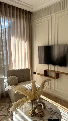 a living room with a couch and a table and a tv at HBkf Residence in Casablanca
