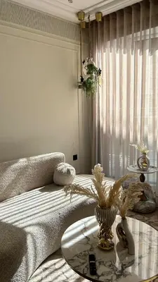 a living room with a table and a bed with a glass table at HBkf Residence in Casablanca