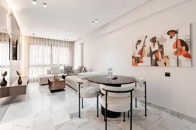 a living room with a table and a couch at Maârif Elegance et confort in Casablanca