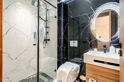 a bathroom with a shower and a toilet and a sink at Maârif Elegance et confort in Casablanca