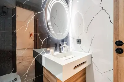 a bathroom with a white sink and a mirror at Maârif Elegance et confort in Casablanca
