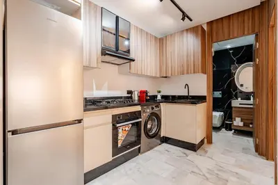 a kitchen with a stove and a washer and dryer at Maârif Elegance et confort in Casablanca