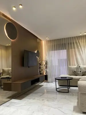 a living room with a couch and a flat screen tv at VIVASTAY Casablanca - Cosy Maarif Arena 41 in Maarif