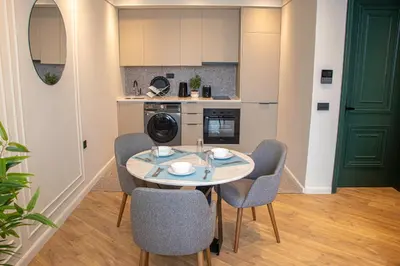 a kitchen with a table and chairs in a room at VIVASTAY Casablanca -Corniche Le claridge Emerauld with gym and rooftop in Casablanca