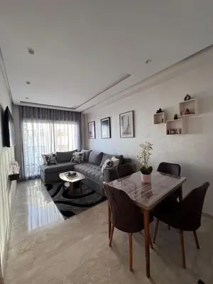 a living room with a couch and a table at Nova Casa in Casablanca